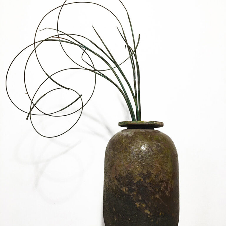 Ceramic pot with curling metal grass